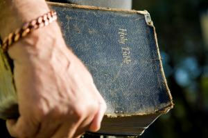 Hand Holding Old Bible
